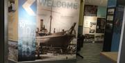 Picture shows welcome greeting with shipbuilding scene.