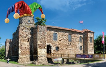 A picture of Colchester Castle with a Jester's hat superimposed on one of the towers