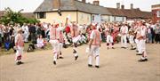 Thaxted Morris men dancing in village