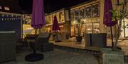Piglets' Mediterranean style patio at night ready for guests dining al-fresco