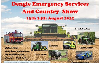 Field with a combine harvester, fire engine, tractor, emergency vehicles and a horse