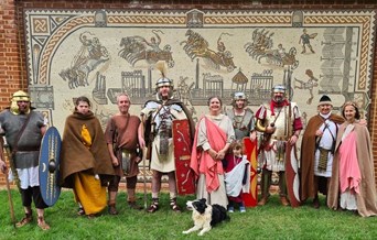 Roman re-enactors in front of a modern day mosaic