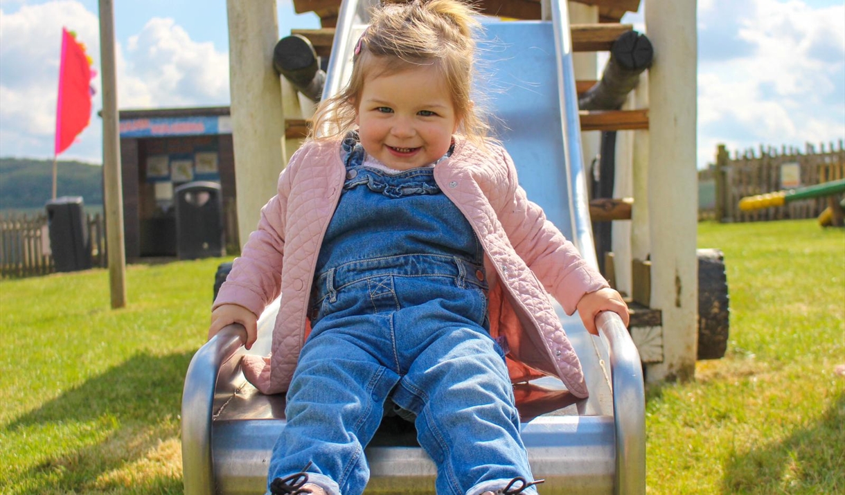 Little girl sliding down a slide Little girl sliding down a slide