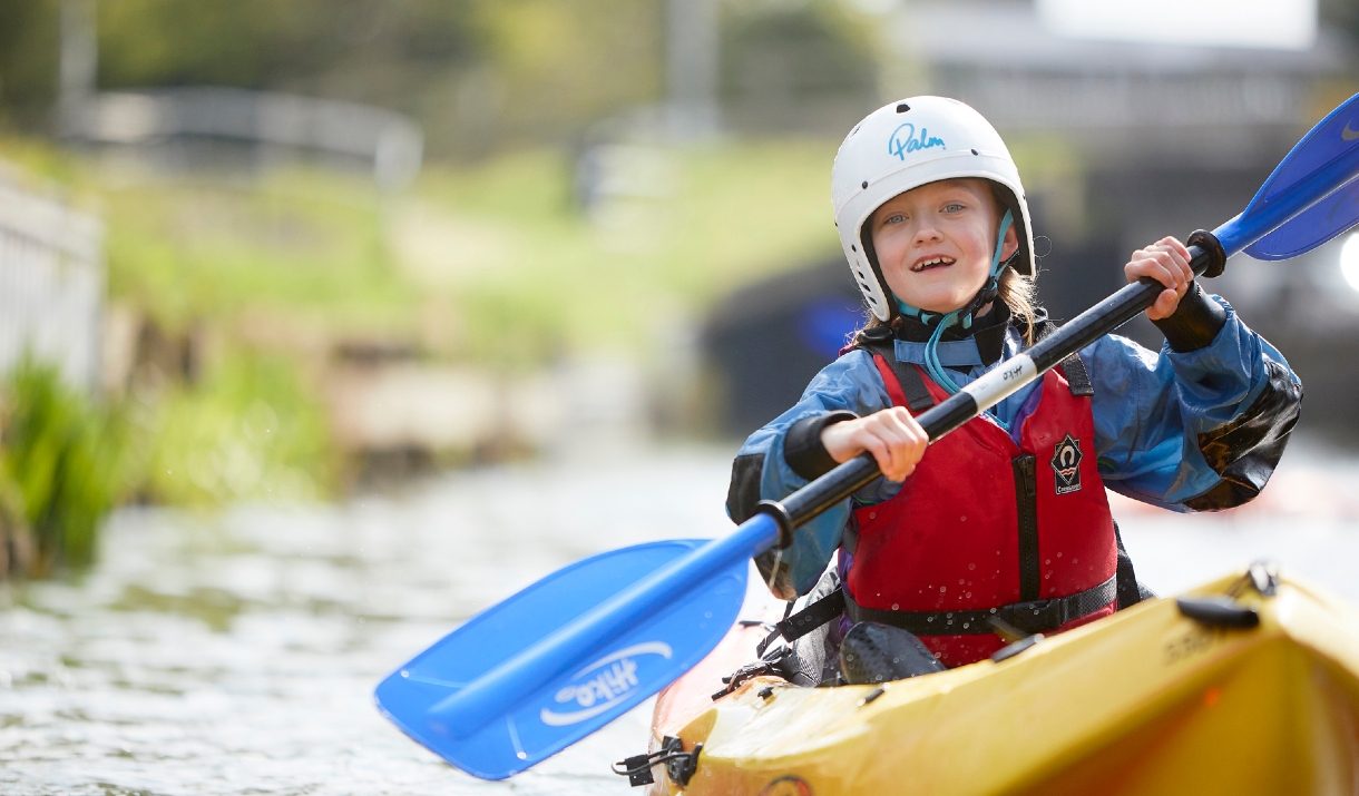 smiling girl in yellow kayak