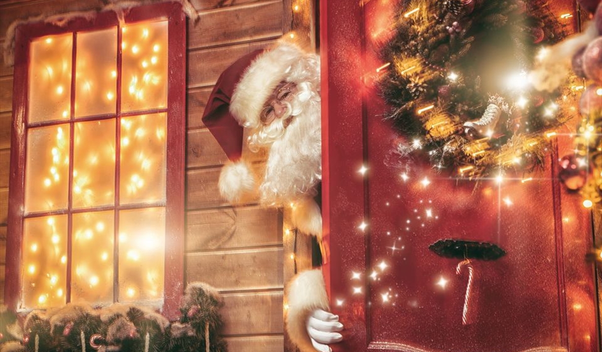Santa pokes his head out of a door