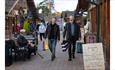 Two men walking through the Trentham Shopping Village.
