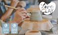 A close-up image of a visitor painting an up-turned bowl or cup