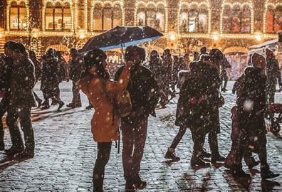 Busy and snowy cobbled street
