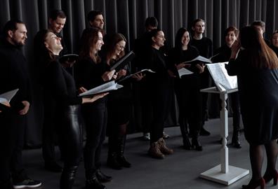 Group of people in black outfits about to sing