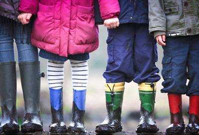 Four kids with muddy boots