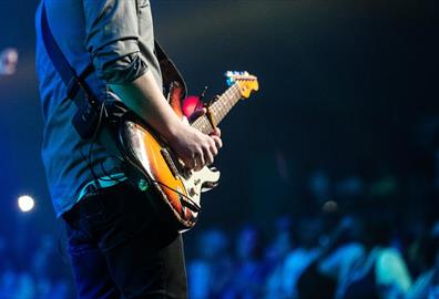 Guitarist playing to a large crowd