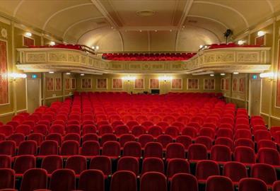 Empty red seats in a theatre