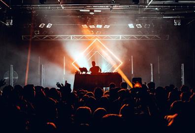 DJ performing in front of a crowd in a club