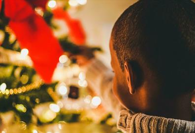 Small child close to Christmas tree