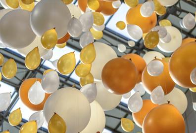 White and gold balloons tied to a string