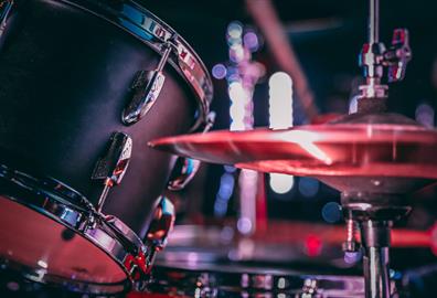 Black acoustic drum set with shiny hi hat