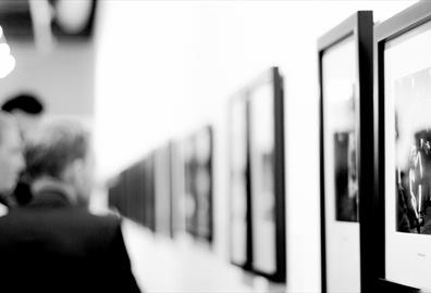 People looking at art on a wall