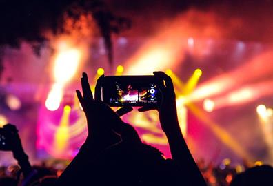 People at a concert taking pictures with phones