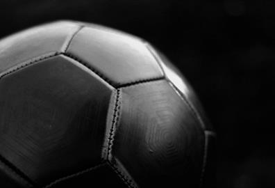 Black football on dark background