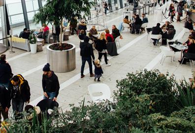 Green cafe space with people at Christmas