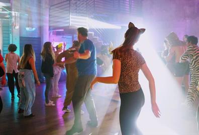 Costume dance party with bright lights