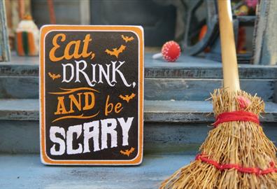 Eat drink and be scary sign with wooden broom