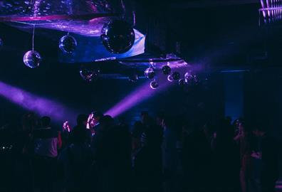 People dancing in purple club