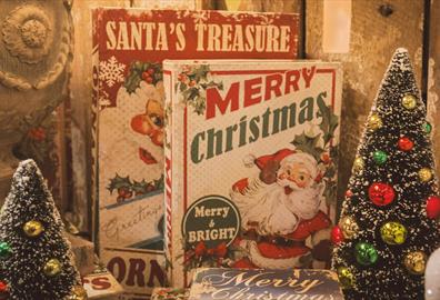 Books with Santa on the front and two tiny Christmas trees