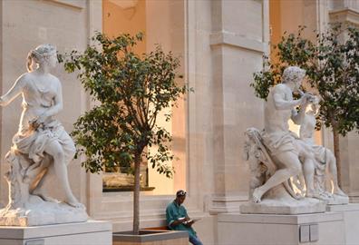 White marble statues outside museum