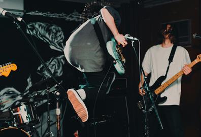 Guitarist jumping on stage