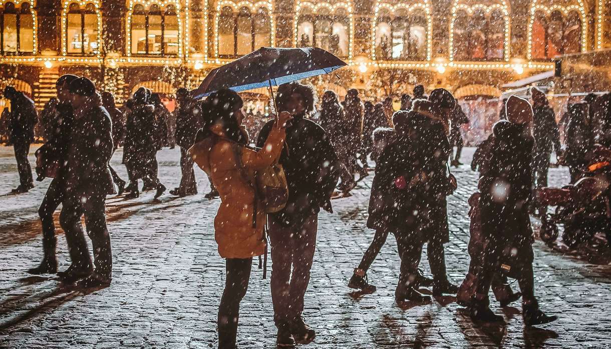 Busy and snowy cobbled street