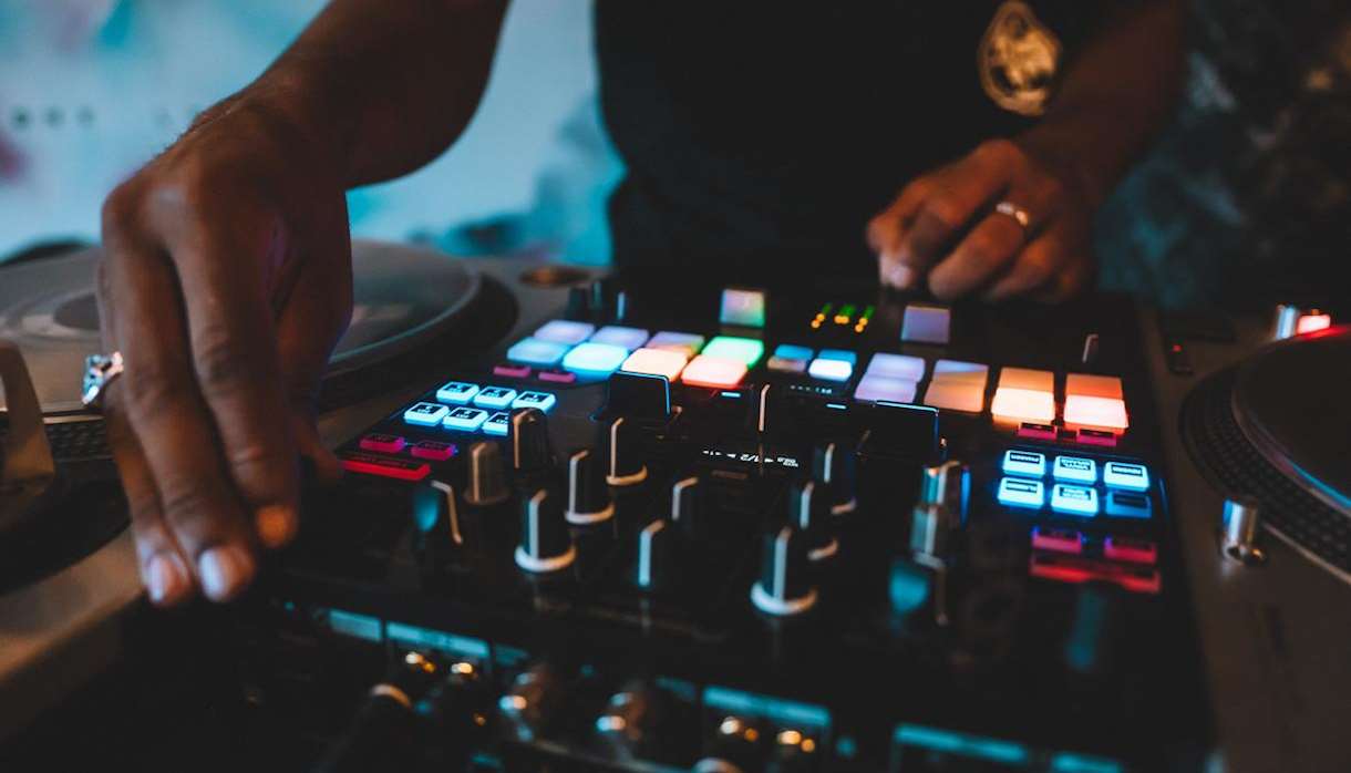 DJ using a turntable with multicoloured lights
