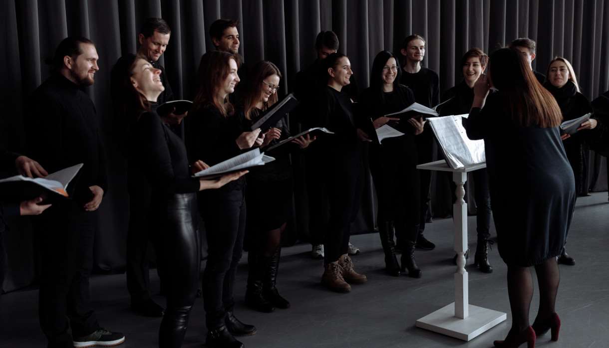 Group of people in black outfits about to sing