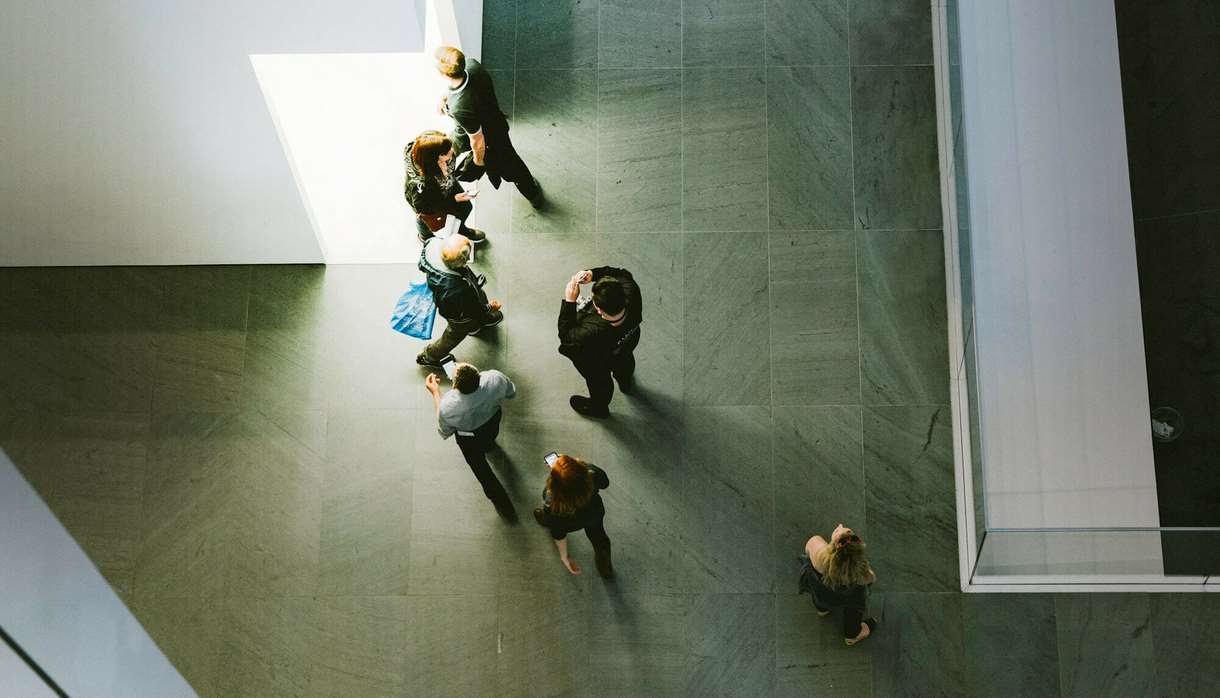 Top down view of people in grey space