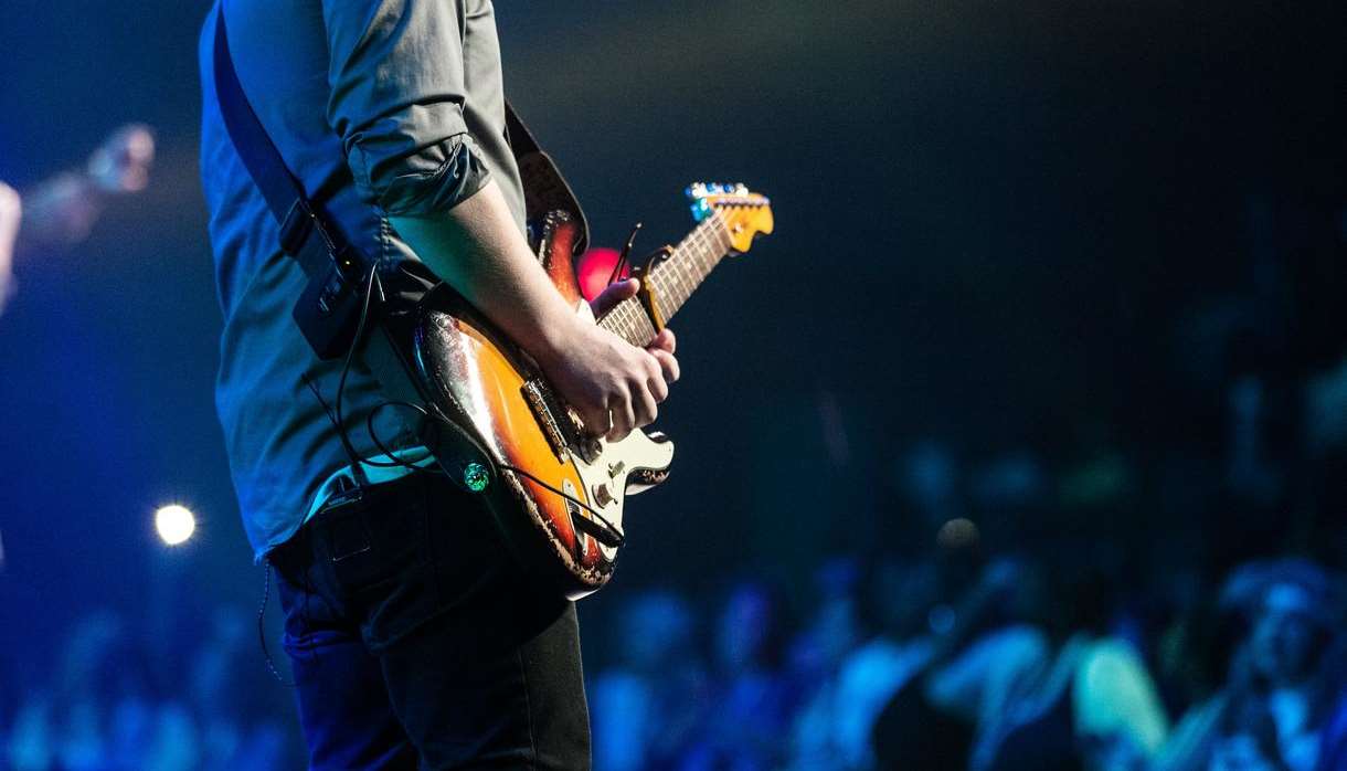 Guitarist playing to a large crowd