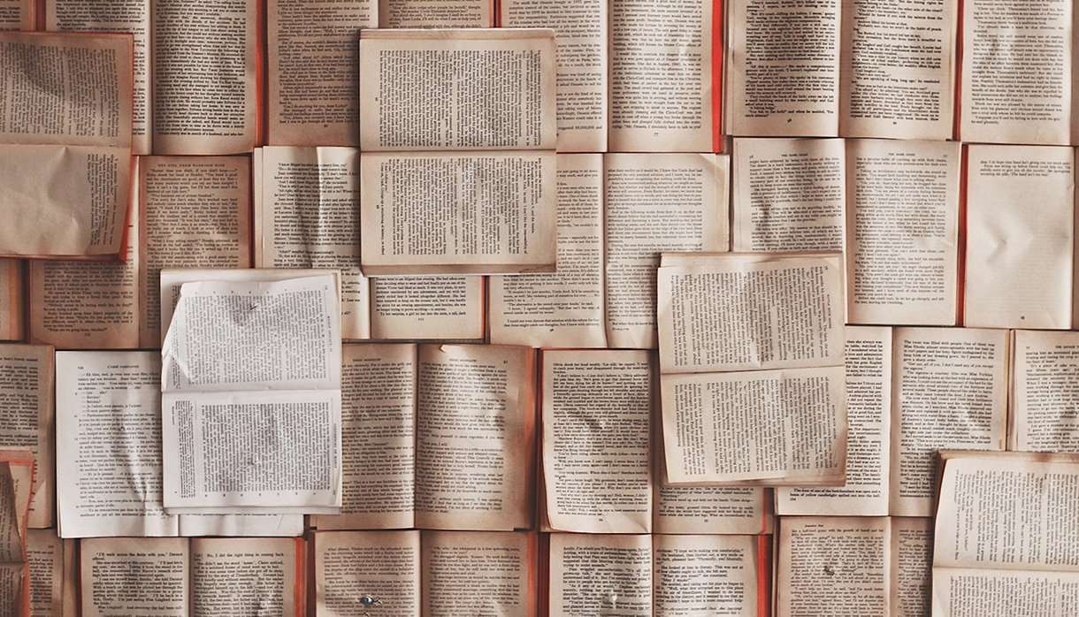 Many open books laid out together