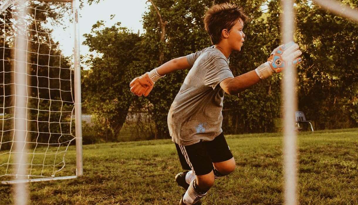 Boy playing football goalkeeper