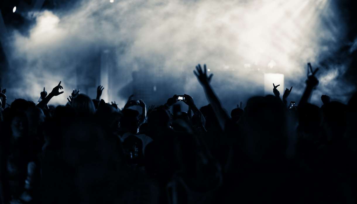 Grey and blue smoke over crowd at nightclub