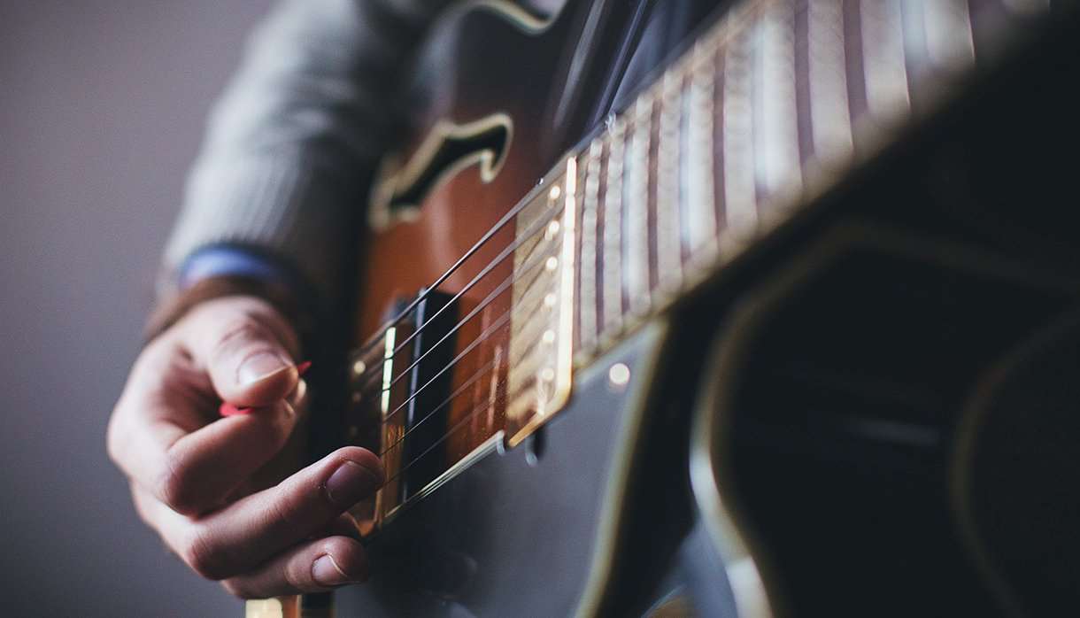 Person playing a guitar