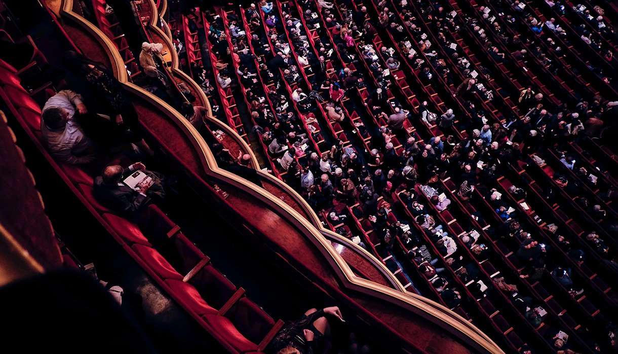 Audience sitting in a performance theatre