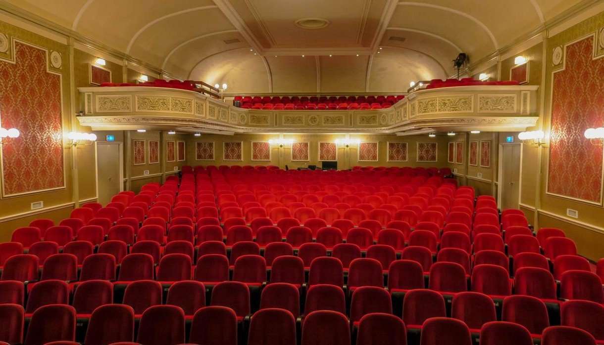 Empty red seats in a theatre