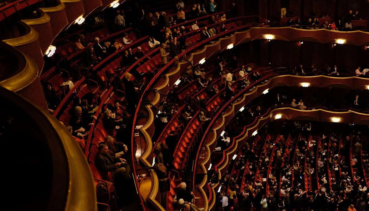 Audience sitting in a performance theatre