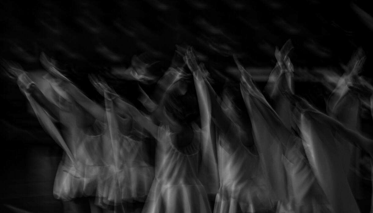 Black and white image capturing dancers in motion