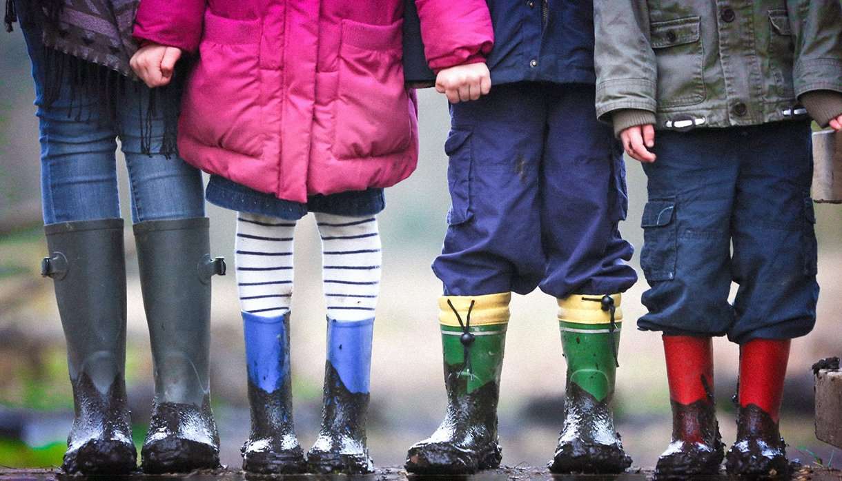 Four kids with muddy boots