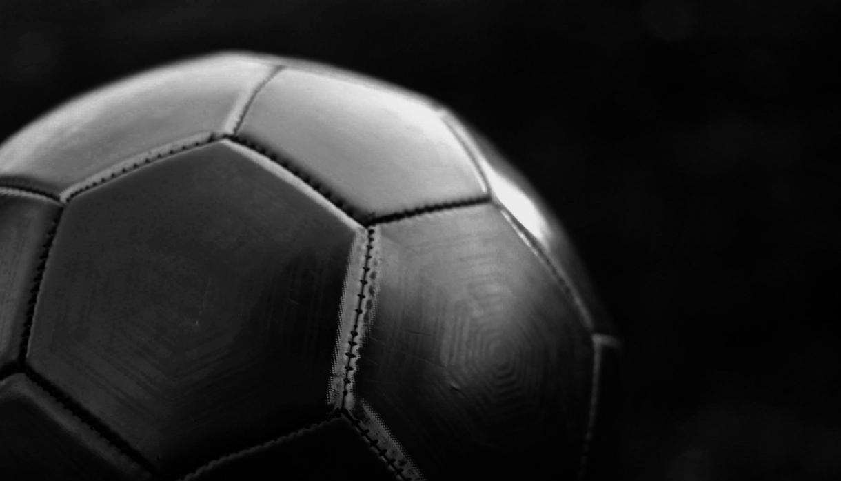 Black football on dark background