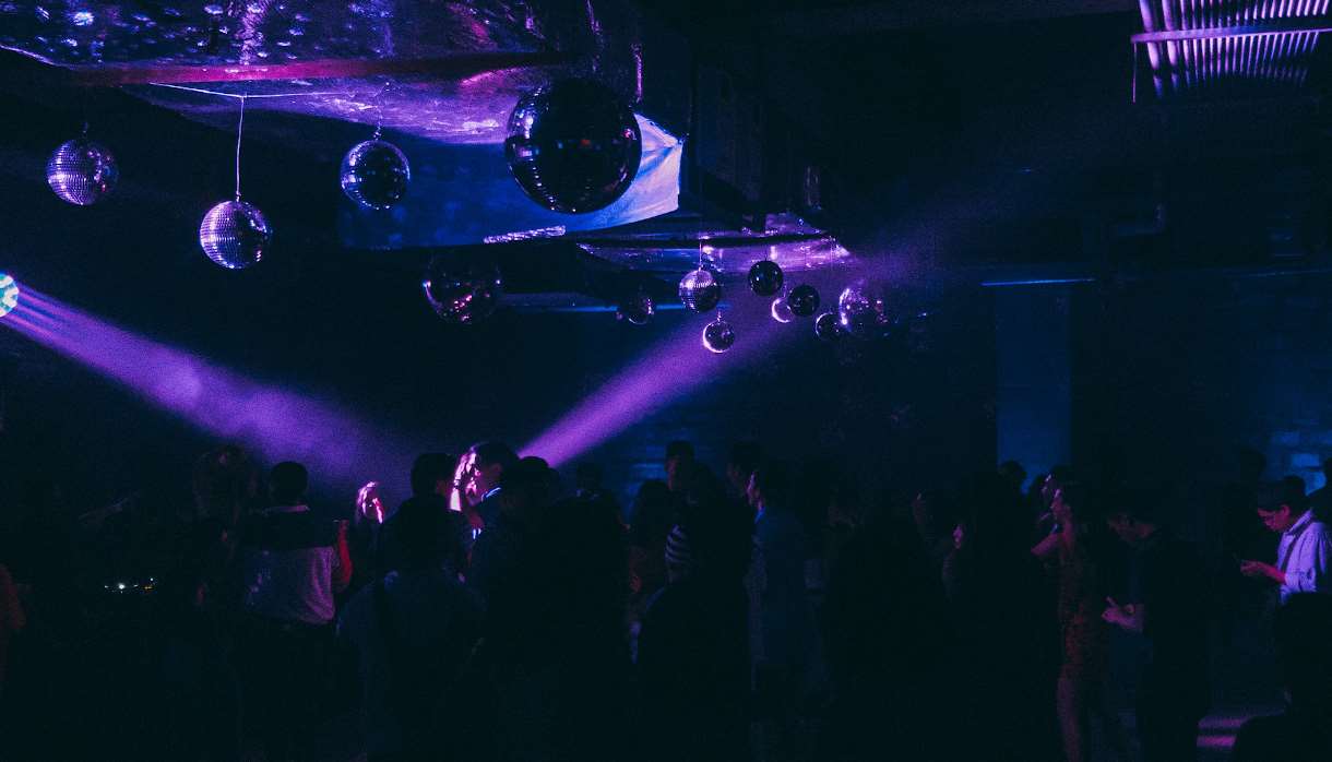 People dancing in purple club