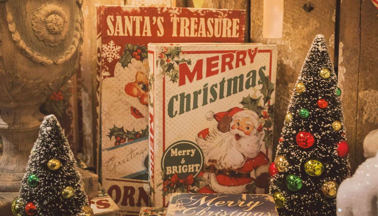 Books with Santa on the front and two tiny Christmas trees