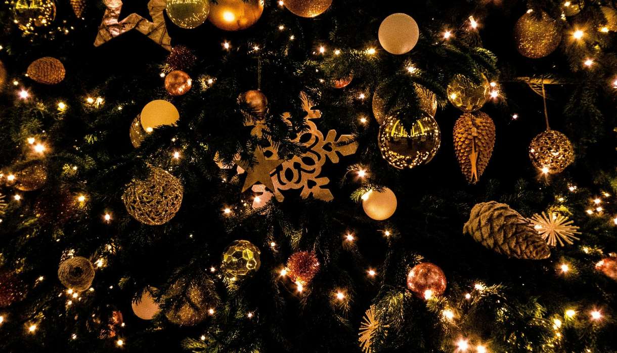 Christmas tree decorated with golden baubles and pinecones