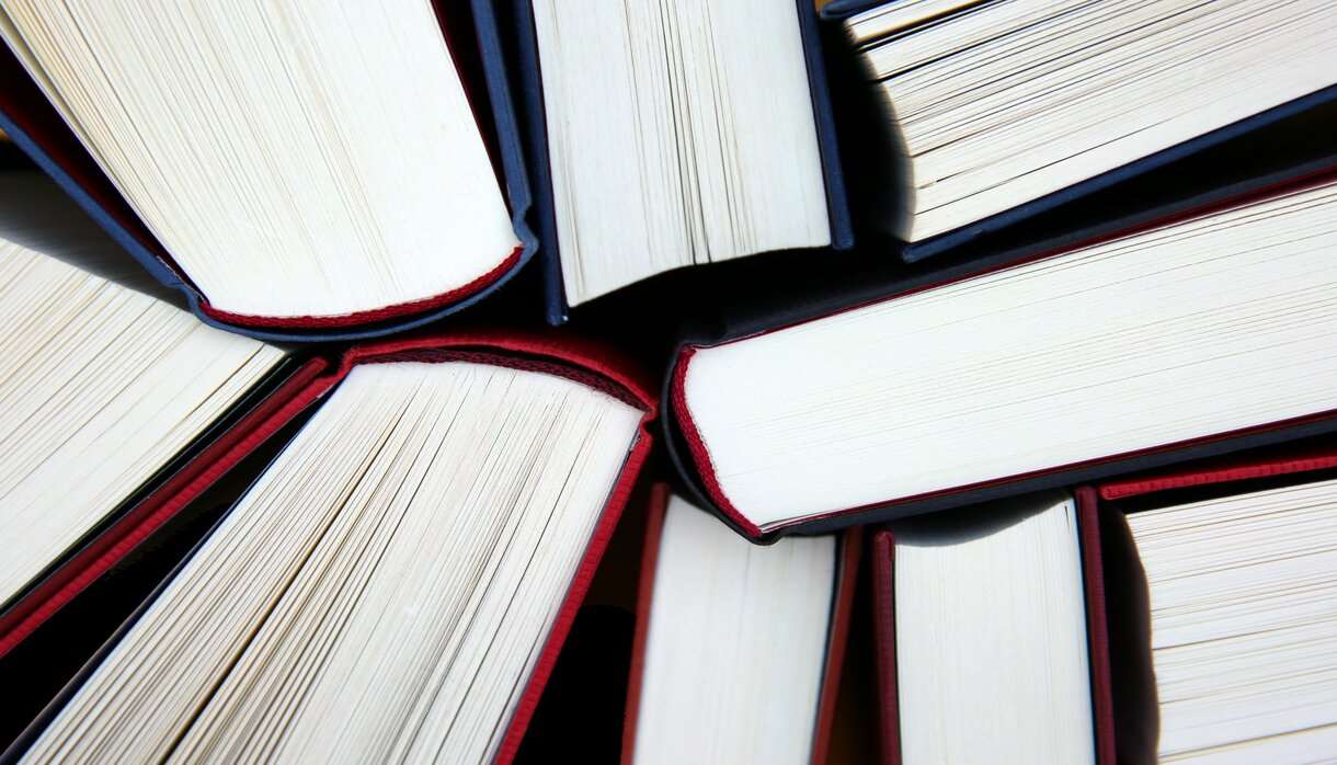 Nine book spines in a cluster from top