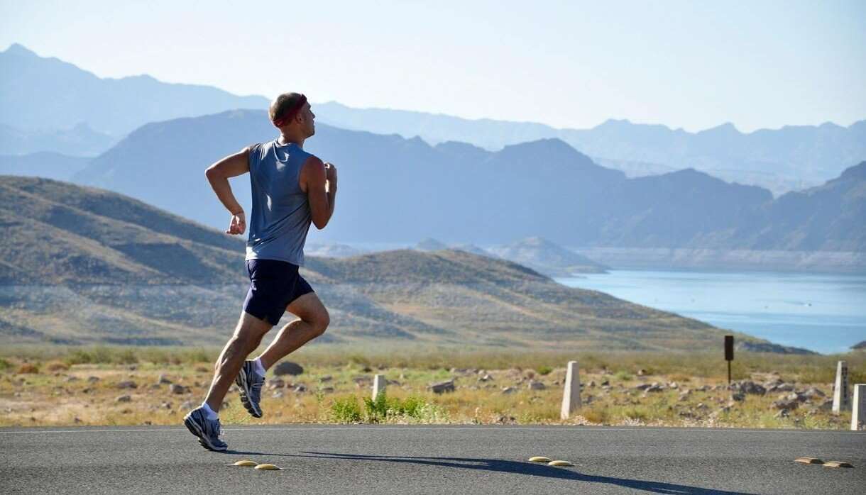 Person running on a scenic road